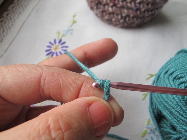 Drawing the stitch through to make a crochet chain stitch