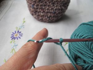Yarn over the crochet hook to make a chain stitch