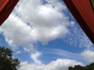 Blue sky with clouds seen from campsite tent