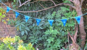 blue floral crochet bunting in tree