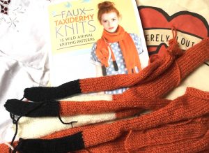 knitted fox legs and book containing fox stole pattern