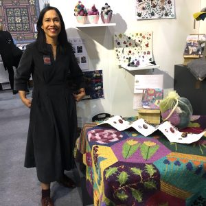 Dee Hardwicke with her throw and book on Rowan stand at Knitting & Stitching Show