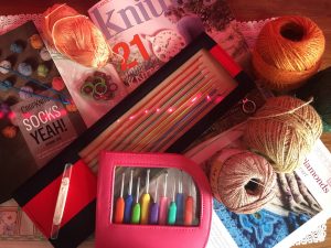 Crochet hooks, wool, twine, magazines and knitting needles