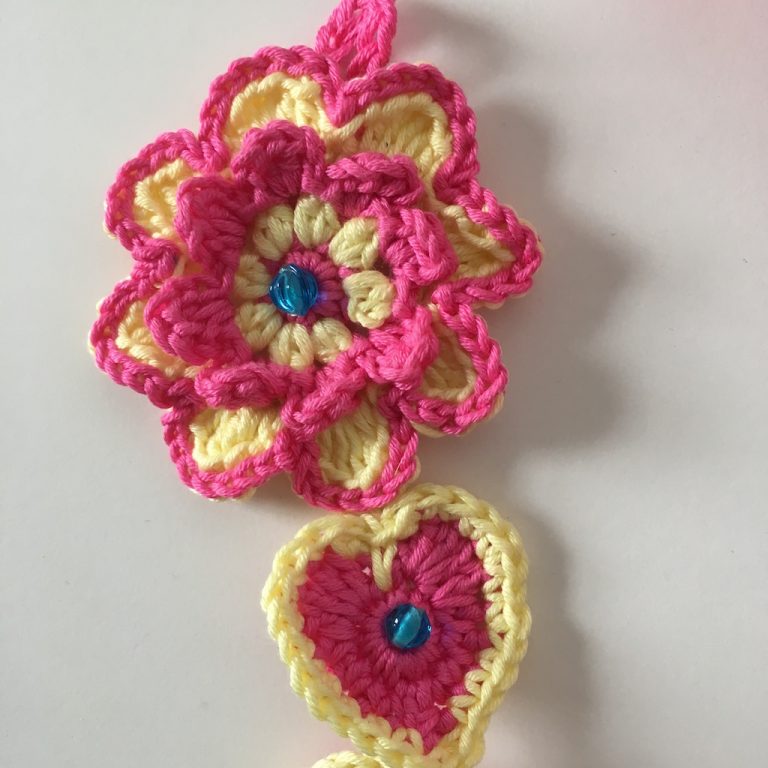 close up of crochet flower and heart