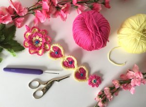 crochet hearts and flowers wall hanging in progress