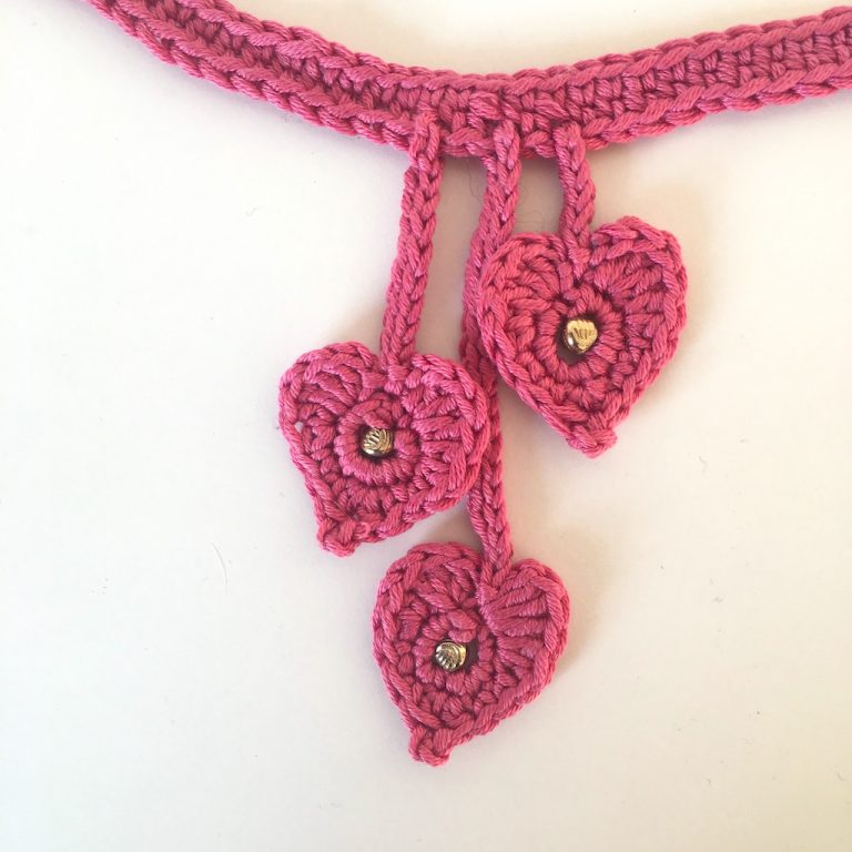 cloe up of three crochet hearts on a choker