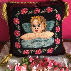 Tapestry cushion cover featuring cherub and flowers