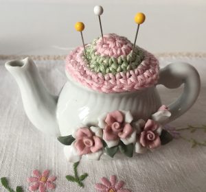 crochet pincushion in little china teapot decorated with roses