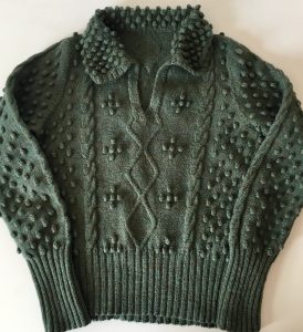 Green version of the bobble and cable sweater desinged by Patricia Hodge