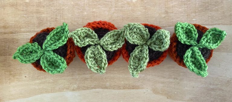 A row of crocheted plantpots