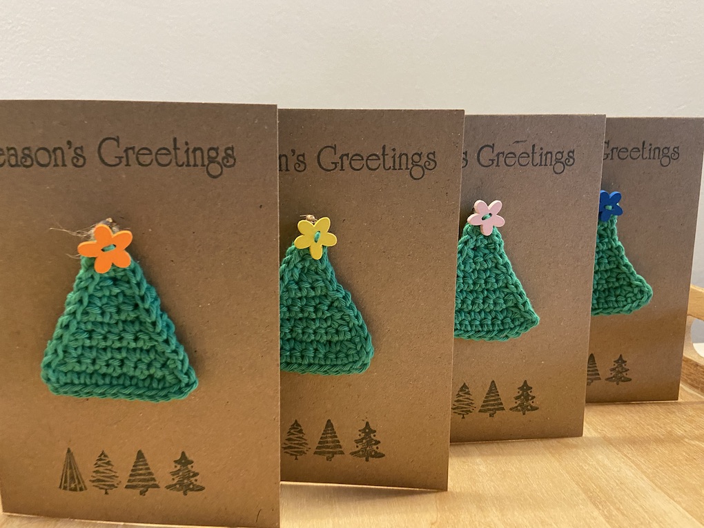 Xmas cards with crocheted tree decorations attached.