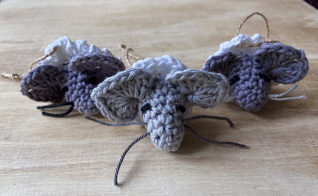 Little crocheted mice with choirboy ruff collars.
